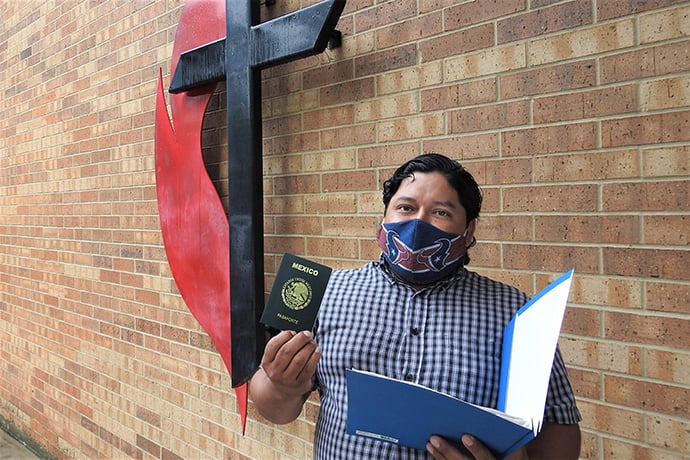 Juan Martinez shows off his renewed Mexican passport outside Kingwood United Methodist Church in northeast Houston. The church provided office space and volunteers as a team from the Mexican Consulate in Houston worked to issue and update official documents for Mexicans living in the Houston area and beyond. Photo by Sam Hodges, UM News.