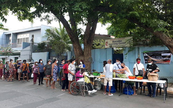 People line up to collect fresh food at a community pantry in Bocobo, Manila, in the Philippines. United Methodists in the region are helping to fight food insecurity during the COVID-19 pandemic. Photo courtesy of Liza Cortez.