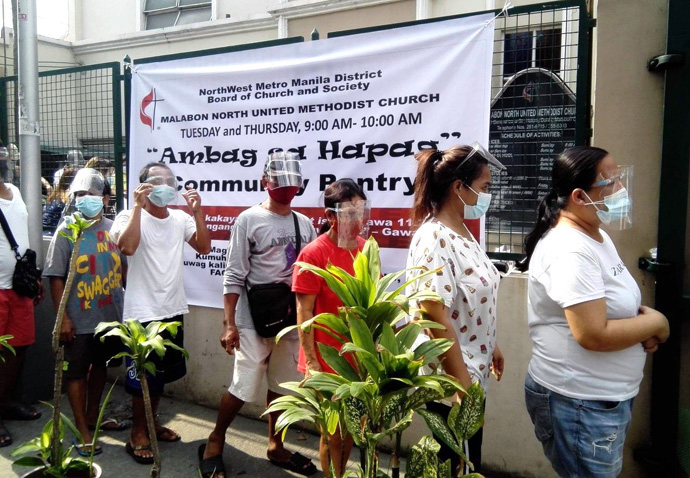 Visitors wait in line at a community pantry led by the NorthWest Metro Manila District Board of Church and Society held outside Malabon North United Methodist Church in Malabon, Philippines. Photo courtesy of the Rev. Charles Jenkin Mendoza.