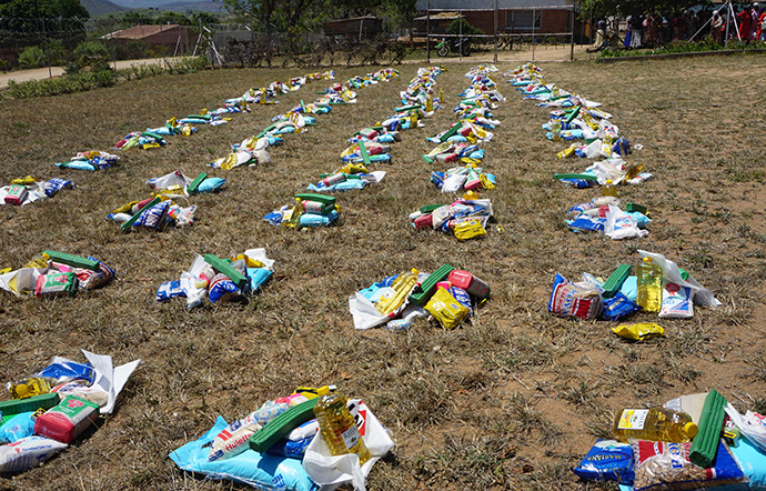 Bundles of food and sanitation supplies are laid out for recipients at the The United Methodist Church’s Mutambara Mission, south of Mutare, Zimbabwe. Photo by Kudzai Chingwe, UM News.