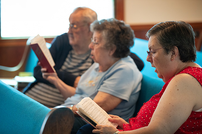 The Ward family sings together during worship at Oakton United Methodist Church outside Clinton, Ky. From left are: Thomas and Sue Ward and their daughter, Pam Ward. Photo by Mike DuBose, UM News.