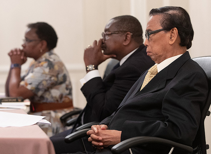 Members of the United Methodist Judicial Council listen during an oral hearing at their meeting in Evanston, Ill., in October 2019. From left are: the Rev. J. Kabamba Kiboko, N. Oswald Tweh Sr. and Ruben T. Reyes. Reyes died on Sept. 13. File photo by Mike DuBose, UM News.