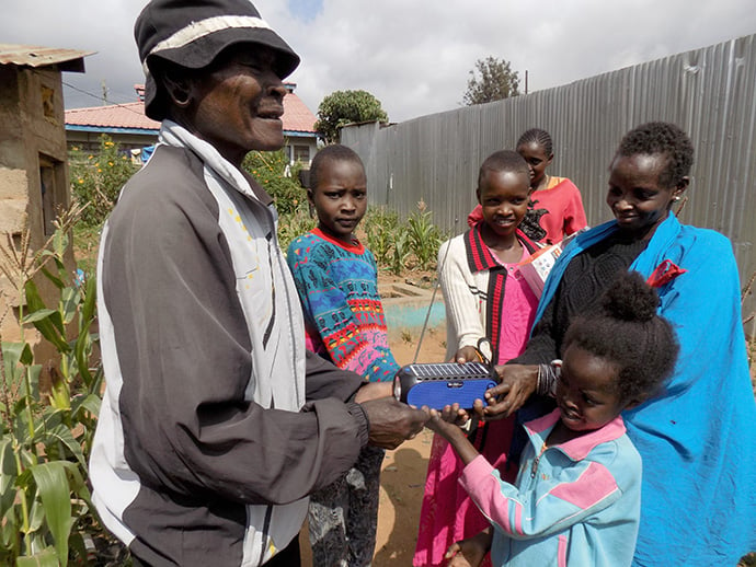 Saloton Ntutu and his family in Narok, Kenya, enjoy listening to Masai songs on Trinity FM. They received the radio as a donation from Trinity United Methodist Church. Photo by Faith Wanjiru, UM News.