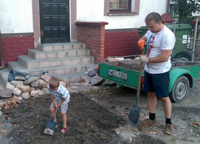 The Rev. Dariusz Zuber gets a little help from his son, Staś, while working in the churchyard at God’s Love United Methodist Church in Ełk, Poland. Photo courtesy of the Rev. Dariusz Zuber.