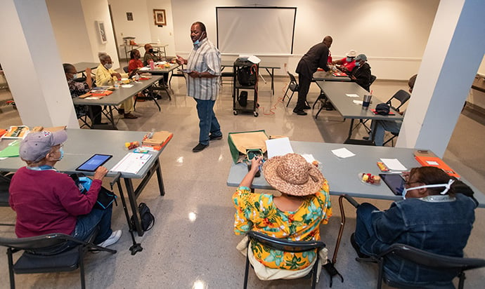 Julius Witherspoon (center) teaches seniors how to use their new tablet computers as part of Project Connect at Gordon Memorial United Methodist Church in Nashville, Tenn. Witherspoon, a member at Gordon, serves as project manager for the program. Photo by Mike DuBose, UM News.