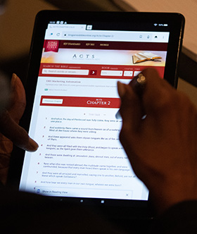 A student uses a tablet computer to read from the second chapter of Acts during a meeting of Project Connect. Photo by Mike DuBose, UM News.