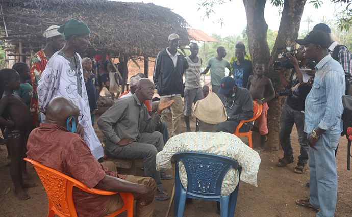 A fact-finding team from the Council of Churches in Sierra Leone visits with Abdul Turay (seated, center), chief of the Masseneh Village in northern Sierra Leone. The team was investigating pollution caused by gold mining along the Pampana River. Photo by Phileas Jusu, UM News.