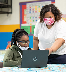 Youth specialist Janet Reyes helps student Alexandria Thompson with her online schoolwork at Bethlehem Centers. Photo by Mike DuBose, UM News.