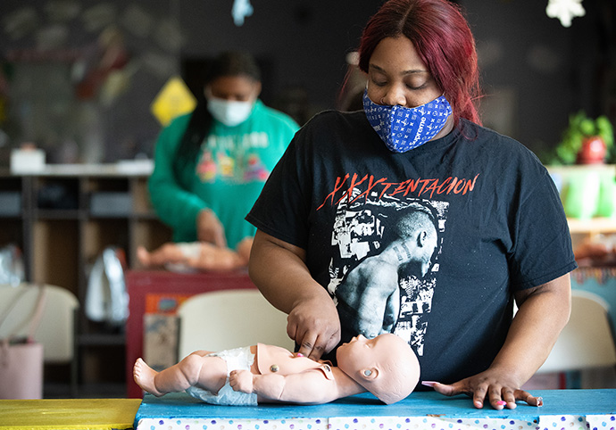 Nkosi Begley (front) and Semari Murphy undergo CPR training at Bethlehem Centers. Photo by Mike DuBose, UM News.