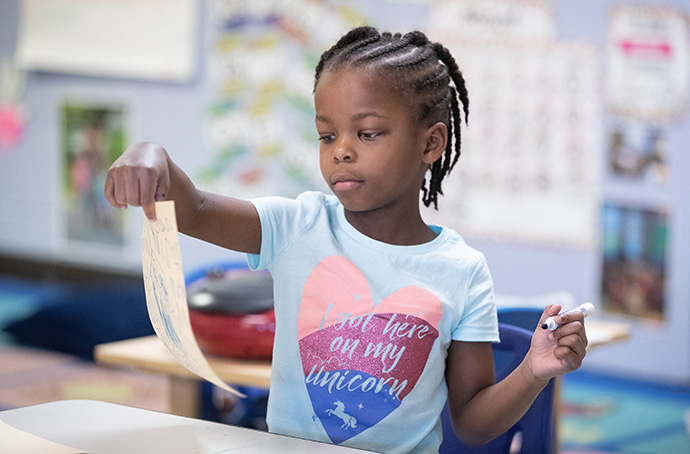 Daycare student MiKayla works on an art project at Bethlehem Centers. Photo by Mike DuBose, UM News.