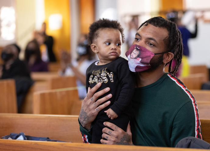 Jordan Haney holds his 8-month-old daughter, Jordyn, during worship Feb. 6 at John Wesley United Methodist Church in Nashville, Tenn. The church offers programs that nurture youth, including a club that help students with problems at school. Photo by Mike DuBose, UM News.