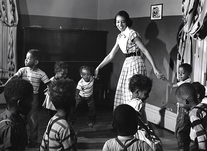 DeLaris Johnson plays with children who came to the Bethlehem Center after school. Her assignment was to keep them occupied until their parents could pick them up. This was her first work assignment while attending Scarritt College for Christian Workers in Nashville, Tennessee. Photo courtesy of Scarritt Bennett Center.