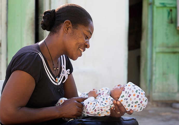 Yolande Gabriel, a maternal health worker for Haiti Artisans for Peace International, checks on one-month-old Rubens Élise Lauture at his home near Mizak, Haiti, in 2013. Haiti Assets for Peace International was among programs that received grants from the United Methodist Board of Global Ministries during its spring meeting. File photo by Mike DuBose, UM News.