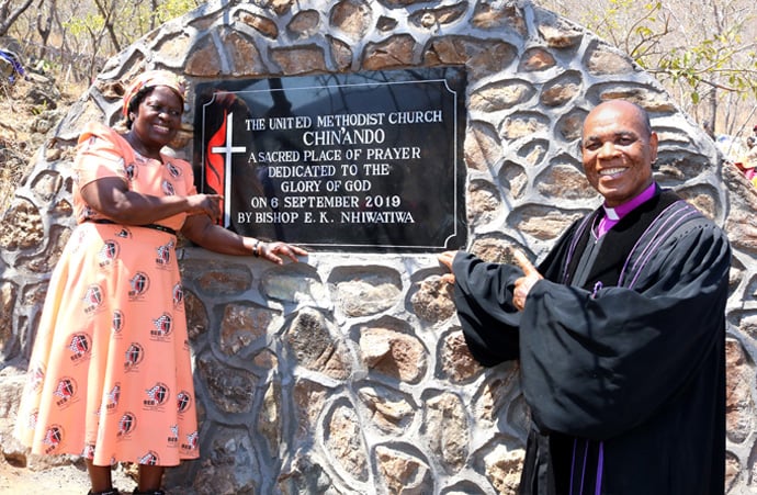 Bishop Eben K. Nhiwatiwa and his wife, Greater Taremeredzwa Nhiwatiwa, celebrate the unveiling of a plaque at the 2019 dedication of the Chin’ando prayer shrine in Old Mutare, Zimbawe. Mbuya Lydia Chimony, who founded the shrine, was a bishop’s wife. Greater Taremeredzwa Nhiwatiwa shares her own life story in her new book, “Reflections on My Life and Faith Journey as an African Bishop’s Spouse.” File photo by the Rev. Taurai Emmanuel Maforo, UM News.