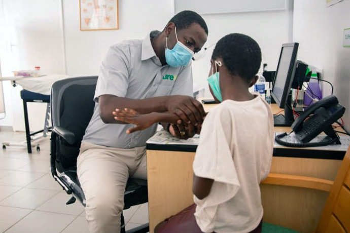 Dr. Tongai Chitsamatanga examines a young patient at Cure Children’s Hospital of Zimbabwe in April. Chitsamatanga, the second pediatric orthopedic surgeon in Zimbabwe, began his medical career the United Methodist-related Mutambara Mission Hospital in the remote mountains of the Chimanimani district. Photo by Cure Zimbabwe, UM News.