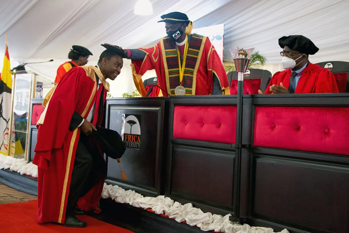 Africa University Chancellor Bishop Gaspar Joao Domingos of the West Angola Episcopal Area caps Tichaona Goto, one of the first doctorate graduates, during the university’s June 11 graduation ceremonies. Photo courtesy of Africa University.