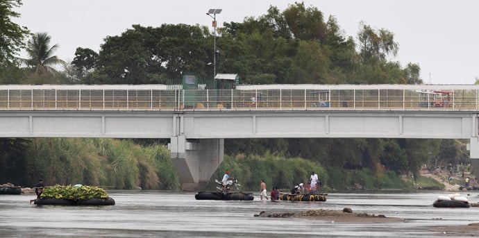 Rafters transport people and goods across the Suchiate River, which forms part of the border between Guatemala and Mexico, near Ciudad Hidalgo, Mexico. The busy, informal crossing is just yards downstream from the formal border crossing at the Rodolfo Robles Bridge. Photo by Mike DuBose, UM News.