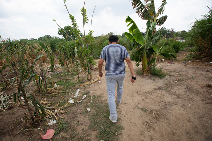 The Rev. Uzi Castañeda Morales tours a well-worn path in Ciudad Hidalgo, Mexico, that is used by migrants to cross the Suchiate River, which forms part of the border between Guatemala and Mexico. Morales, pastor of El Divino Salvador Methodist Church in Tlaxcala, Mexico, was part of a fact-finding mission to Mexico’s southern border for leaders of the Methodist Church in Mexico and The United Methodist Church. Photo by Mike DuBose, UM News.