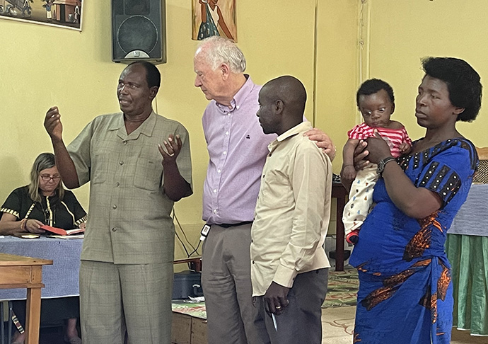 The Rev. Marc Baliyanga (left) addresses the HIV-AIDS Conference in Kilgali, Rwanda. Baliyanga is dean of the Rwanda United Methodist Provisional Conference. HIV-AIDS and COVID-19 have created a “twin pandemic,” according to the Rev. Donald E. Messer (second from left), secretary of the United Methodist Global AIDS Committee. Photo by William Bradford.