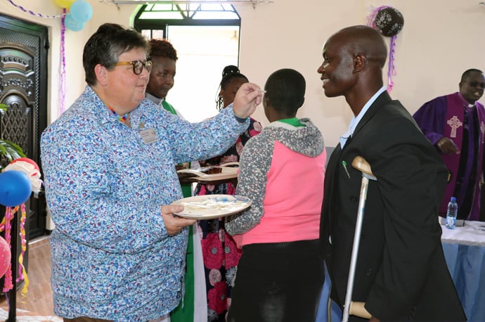 Helen Ryde, Reconciling Ministries Network regional organizer and a home missioner, serves Holy Communion at First United Methodist Church Moheto during the dedication of the church’s sanctuary in the Nyanza District of Kenya. Photo by Gad Maiga, UM News.