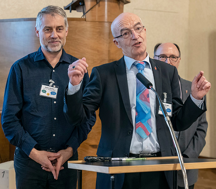 Bishop Patrick Streiff (center) speaks after the election of the Rev. Stefan Zürcher (left) to serve as bishop of the United Methodist Central and Southern Europe Central Conference. Streiff, who will retire in August of 2023, will have led the conference for more than 17 years. At right is Bishop David Bard, who leads the Dakotas-Minnesota and Michigan areas in the U.S. Photo by the Rev. Joerg Niederer.