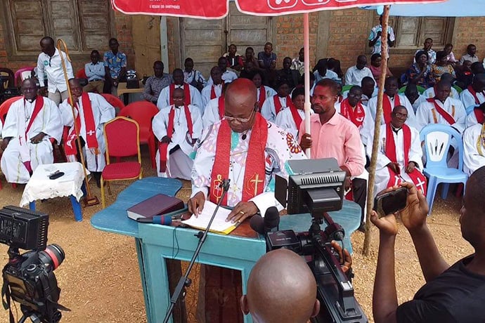 East Congo Bishop Gabriel Yemba Unda prepares remarks during a celebration in Kindu, Congo, in which the bishop received a new 4x4 vehicle from Congolese President Félix Antoine Tshisekedi Tshilombo. Unda said the gift is “a mark of recognition of the activities of The United Methodist Church.” Photo by Judith Osongo Yanga, UM News. 