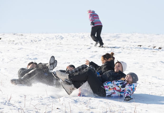 Youth from Livespring United Methodist Church in Kara-Balta and neighborhood guests enjoy an afternoon of sliding down a snowy hillside. Photo by Mike DuBose, UM News.