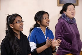 Marshaline Anand (left) and Abby Abheepsa Sagar (center) join in singing at Bishkek United Methodist Church in Bishkek, Kyrgyzstan. Photo by Mike DuBose, UM News.