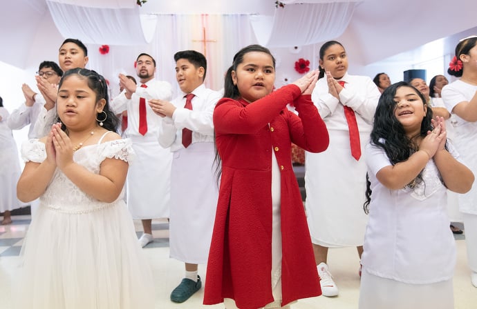 Members of the choir sing during the chartering service. The youth featured prominently in the celebration, performing most of the music. Photo by Mike DuBose, UM News.