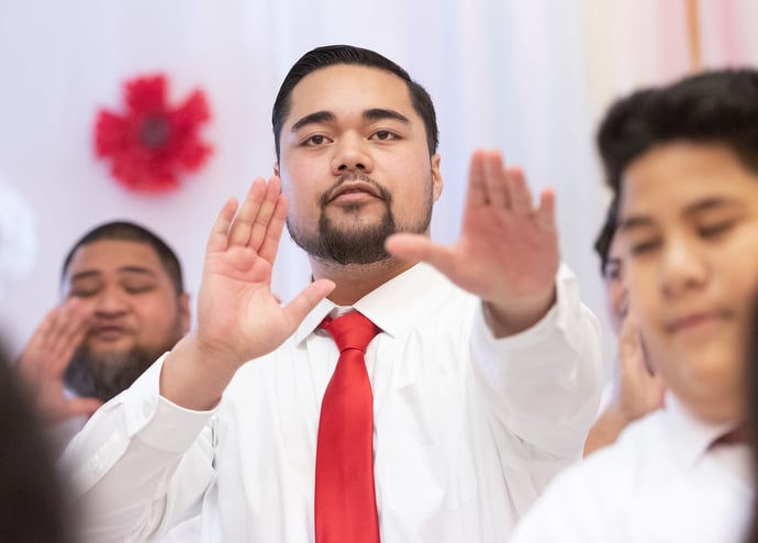 Tinius Levao (center) gestures during a song. Photo by Mike DuBose, UM News.