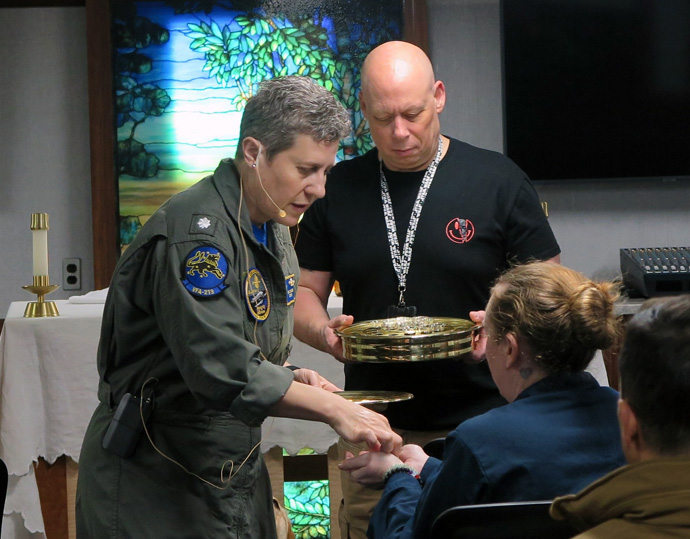 U.S. Navy Commander Genevieve Clark conducts a worship service aboard the USS Gerald R. Ford. She is a United Methodist clergywoman and Navy chaplain. Photo courtesy of Genevieve Clark.