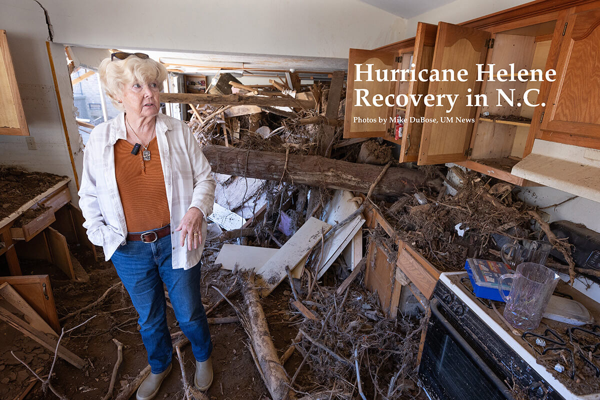 Church member Sherrie Mayotte views damage to the kitchen at Pensacola United Methodist Church in Burnsville, N.C., after it was flooded by storm runoff following Tropical Storm Helene. The nearby Cane River overflowed its banks and drove a wall of water packed with mud, trees and parts of destroyed homes into the church fellowship hall and kitchen. Photo by Mike DuBose, UM News.