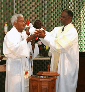 In an undated photo, the Rev. James Lawson Jr. (left) and the Rev. Henry Masters, former pastors at Holman United Methodist Church in Los Angeles, officiate at a baptism at the church. Lawson, a civil rights icon, passed away in 2024, while Masters is retired and living in Dallas. He is the publisher of By Faith magazine about Black United Methodists. File photo courtesy of Holman United Methodist Church.